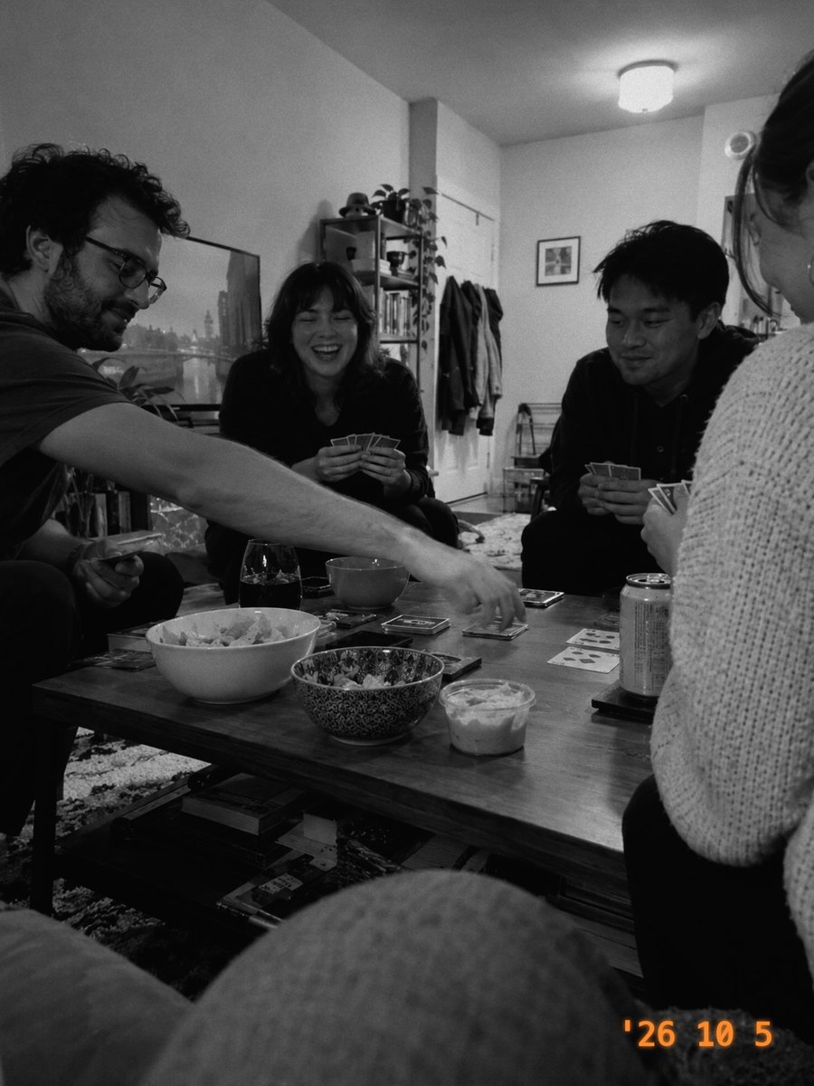 Friends playing cards around a coffee table, in Mono