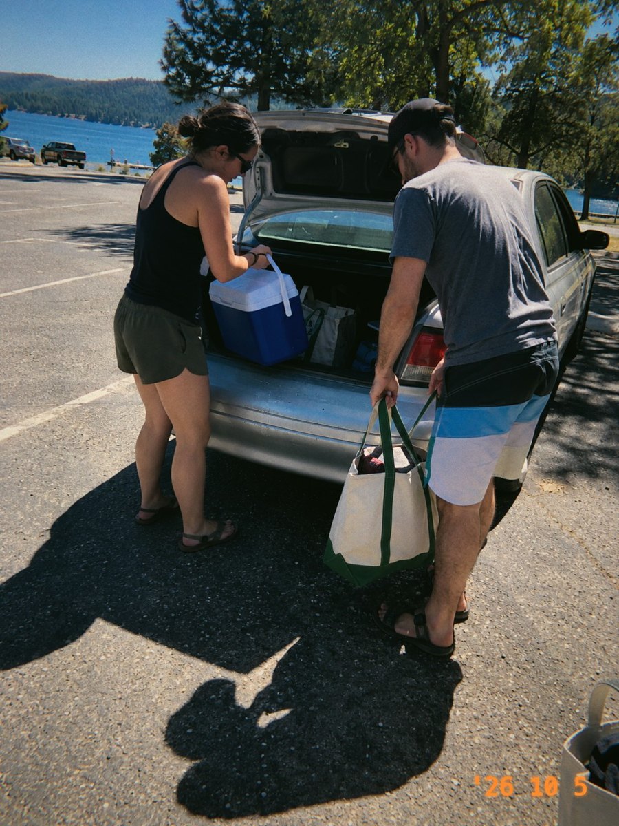 Two friends unloading a car by a lake, in Jamm 400